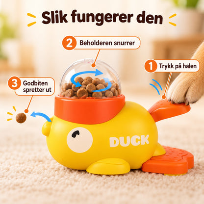 Slik fungerer GodbitAnda: trykk på halen, beholderen snurrer og godbiten spretter ut