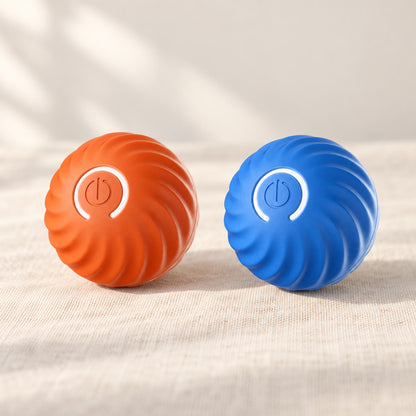 Ballen automatisk rullende lekeball i oransje og blått, på lin